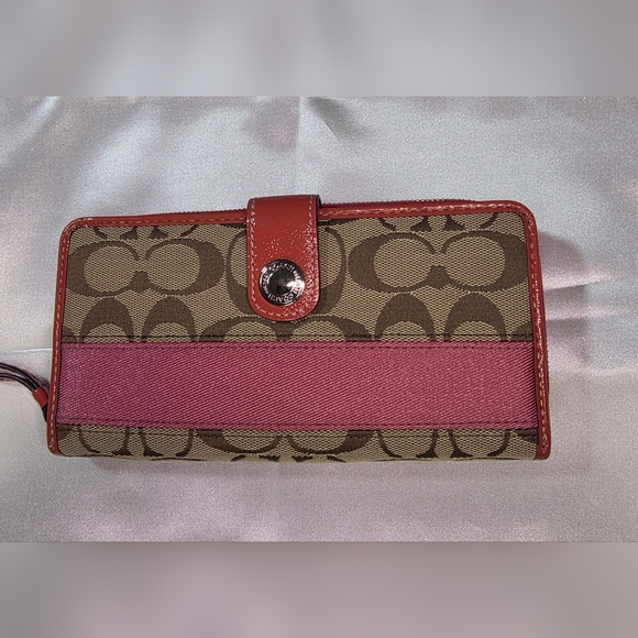 Coach signature canvas wallet with pink leather and a pink accent stripe